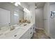 Modern bathroom with double vanity, quartz countertop, and a walk-in shower at 725 Essex Ave, Port Charlotte, FL 33948
