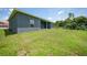 Spacious backyard with covered patio and grassy area at 725 Essex Ave, Port Charlotte, FL 33948