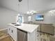 Open concept kitchen with island, stainless steel appliances, and living room view at 725 Essex Ave, Port Charlotte, FL 33948
