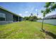 Large backyard with covered patio and grassy area at 725 Essex Ave, Port Charlotte, FL 33948