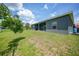 Spacious backyard with covered patio and grassy area at 725 Essex Ave, Port Charlotte, FL 33948