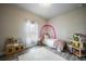 Charming bedroom with rainbow wall art, a twin bed, and a play area at 725 Essex Ave, Port Charlotte, FL 33948