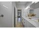 Double vanity bathroom with a view of a bedroom at 725 Essex Ave, Port Charlotte, FL 33948