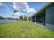 Large backyard with covered patio and grassy area at 725 Essex Ave, Port Charlotte, FL 33948