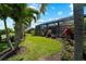 Expansive pool and patio area with tropical landscaping and screened enclosure at 13948 Miranese St, Venice, FL 34293