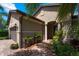 Welcoming house entrance with brick pavers and lush landscaping at 13948 Miranese St, Venice, FL 34293