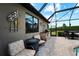 Outdoor kitchen with built-in grill and seating area at 13948 Miranese St, Venice, FL 34293