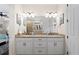 Elegant bathroom with double vanity, granite counters, and large mirror at 13948 Miranese St, Venice, FL 34293