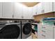 Laundry room with Samsung washer and dryer, and ample cabinet space at 13948 Miranese St, Venice, FL 34293