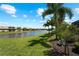 Tranquil canal view with lush landscaping and tropical plants at 13948 Miranese St, Venice, FL 34293