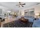 Bright living room with comfortable seating, large windows, and a view of the kitchen at 13948 Miranese St, Venice, FL 34293