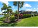 Landscaped backyard with a screened enclosure and lush tropical foliage at 13948 Miranese St, Venice, FL 34293