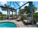 Screened pool area with lounge chairs and a tranquil view at 13948 Miranese St, Venice, FL 34293