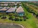Aerial view showcasing home, pool, and surrounding landscape at 13948 Miranese St, Venice, FL 34293