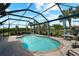 Inviting kidney-shaped pool with a screened enclosure and patio furniture at 13948 Miranese St, Venice, FL 34293