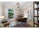 Home office with a desk, window, and comfortable seating area at 13948 Miranese St, Venice, FL 34293
