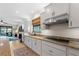 Modern kitchen with granite countertops, stainless steel appliances and breakfast bar at 13948 Miranese St, Venice, FL 34293