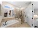 Bathroom with soaking tub and walk-in shower at 13948 Miranese St, Venice, FL 34293