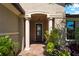 Elegant entryway with columns and lush landscaping at 13948 Miranese St, Venice, FL 34293