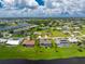 Aerial view of a house with a pool in a residential neighborhood at 1459 Blue Lake Cir, Punta Gorda, FL 33983