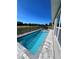 Relaxing rectangular pool with gray stone decking at 16489 Trading Post Rd, Punta Gorda, FL 33955