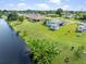 Aerial view of a home featuring a backyard canal with lush tropical foliage enhancing waterfront scenery at 3107 Easy St, Port Charlotte, FL 33952