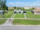 Aerial view of property featuring lush lawn, mature trees, and charming single-story home at 3107 Easy St, Port Charlotte, FL 33952
