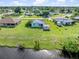 Aerial shot of a home's canal-front backyard, highlighting the waterfront property and adjacent green space at 3107 Easy St, Port Charlotte, FL 33952