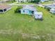 Aerial showing a house with a shed and canal-side yard, emphasizing the outdoor living space at 3107 Easy St, Port Charlotte, FL 33952