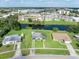 Aerial view of property including lush lawn, mature trees, and charming single-story home at 3107 Easy St, Port Charlotte, FL 33952