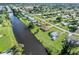 Aerial view of houses along a canal, showcasing waterfront living and neighborhood layout at 3107 Easy St, Port Charlotte, FL 33952