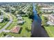 Aerial view of a canal-front neighborhood with lush greenery and clear waterway access at 3107 Easy St, Port Charlotte, FL 33952