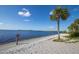 Scenic beach view with white sand and clear blue water on a sunny day at 3107 Easy St, Port Charlotte, FL 33952