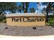 An inviting Port Charlotte community sign surrounded by lush landscaping at 3107 Easy St, Port Charlotte, FL 33952