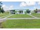 Single-story home featuring a lovely front lawn, a convenient carport, and a charming, welcoming curb appeal at 3107 Easy St, Port Charlotte, FL 33952