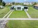 Inviting home with a verdant lawn and decorative features enhancing curb appeal at 3107 Easy St, Port Charlotte, FL 33952