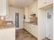 Kitchen featuring white cabinets, granite counters, tile backsplash and stainless steel appliances at 3107 Easy St, Port Charlotte, FL 33952