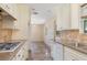 Traditional-style kitchen featuring tile floors, granite countertops and ample cabinet space at 3107 Easy St, Port Charlotte, FL 33952