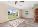 Bright living room features tile flooring, large windows offering natural light, and unique shelving at 3107 Easy St, Port Charlotte, FL 33952