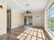 Interior of the home with tile flooring, a ceiling fan, and views of the yard at 3107 Easy St, Port Charlotte, FL 33952