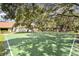 Community basketball court nestled among mature trees at 481 Ricold Ter, Port Charlotte, FL 33954