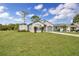House with a large green yard and driveway at 481 Ricold Ter, Port Charlotte, FL 33954