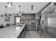 Modern kitchen with gray cabinets and stainless steel appliances at 481 Ricold Ter, Port Charlotte, FL 33954