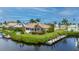 This waterfront property features a private dock and lush landscaping at 5480 Sea Edge Dr, Punta Gorda, FL 33950