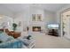 Comfortable living room with a cozy fireplace and large windows at 5480 Sea Edge Dr, Punta Gorda, FL 33950