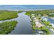 Aerial view of waterfront home showcasing canal access and lush landscaping at 5480 Sea Edge Dr, Punta Gorda, FL 33950