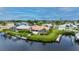 Aerial view of waterfront home with private dock and lush landscaping at 5480 Sea Edge Dr, Punta Gorda, FL 33950