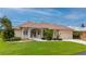 One-story home with tile roof, manicured lawn, and attached garage at 5480 Sea Edge Dr, Punta Gorda, FL 33950
