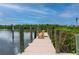 Relaxing dock with wooden chairs overlooking the water at 5480 Sea Edge Dr, Punta Gorda, FL 33950