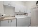Laundry room with washer, dryer, and ample storage at 5480 Sea Edge Dr, Punta Gorda, FL 33950